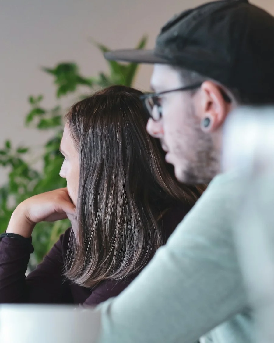 Support analysts helping a user at a computer